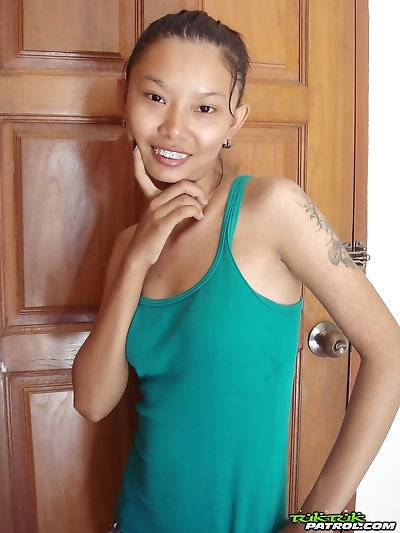Fragile Thai girl takes her panties off and stays naked in doorway
